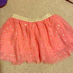 Pink/peach in color with gold sparkles